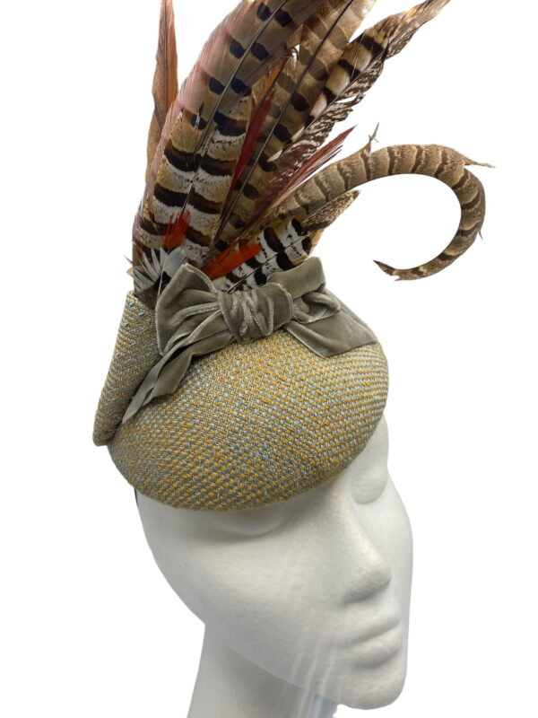 Stunning tweed base headpiece with gorgeous bow detail and a large spray of feathers to finish.